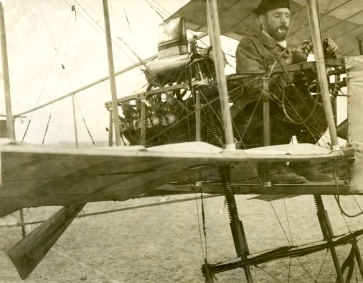 Farman at the controls of the Henri Farman n°1. Notice the spring shock absorbers. (Also, if you see a photo of Farman, he almost always has a cigarette at the ready)