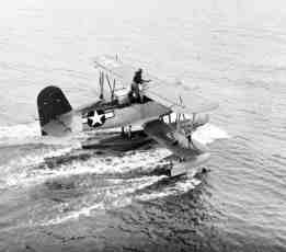 Same aircraft seen in previous photo shows the rearseat man stowing the bridle used when hauling the aircraft in or out of the sea.