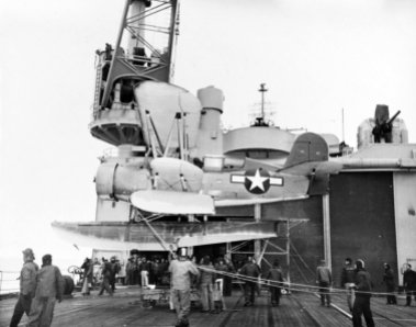 SOC aboard seaplane tender USS Currituck in 1947. The plane is being readied for dropping in the water.